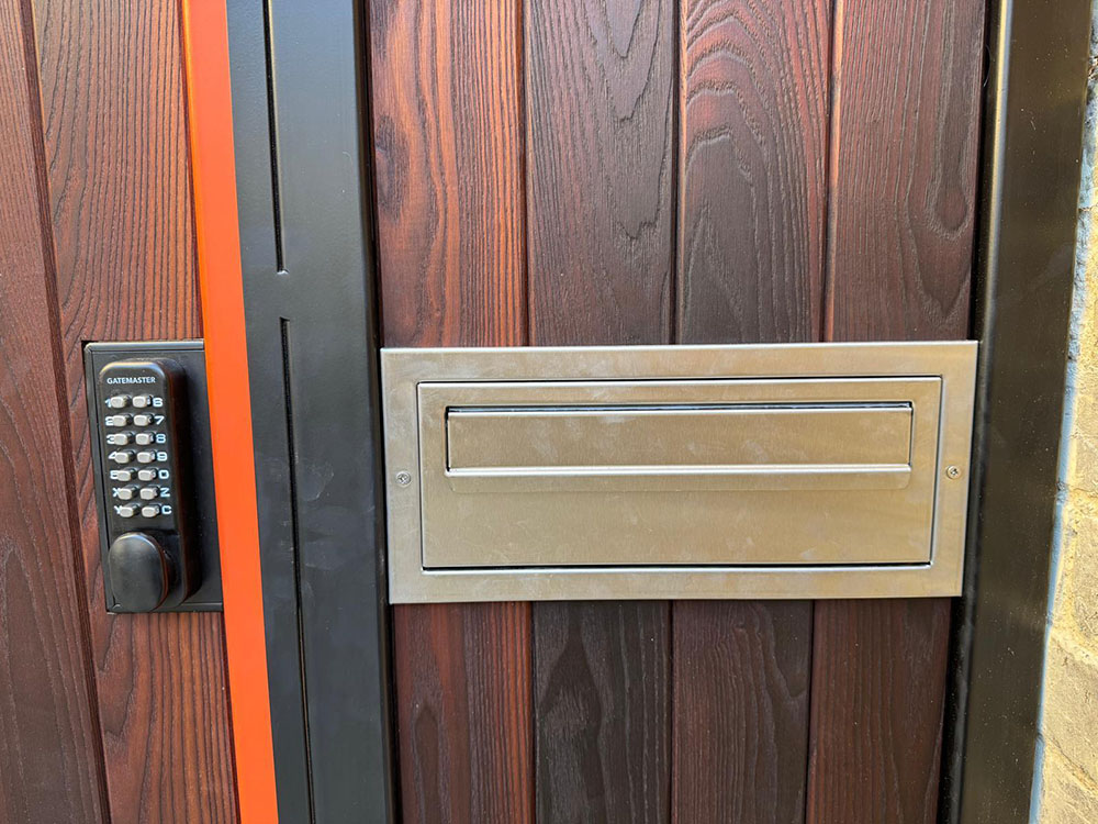 Gate with letter box and mechanical push-button lock